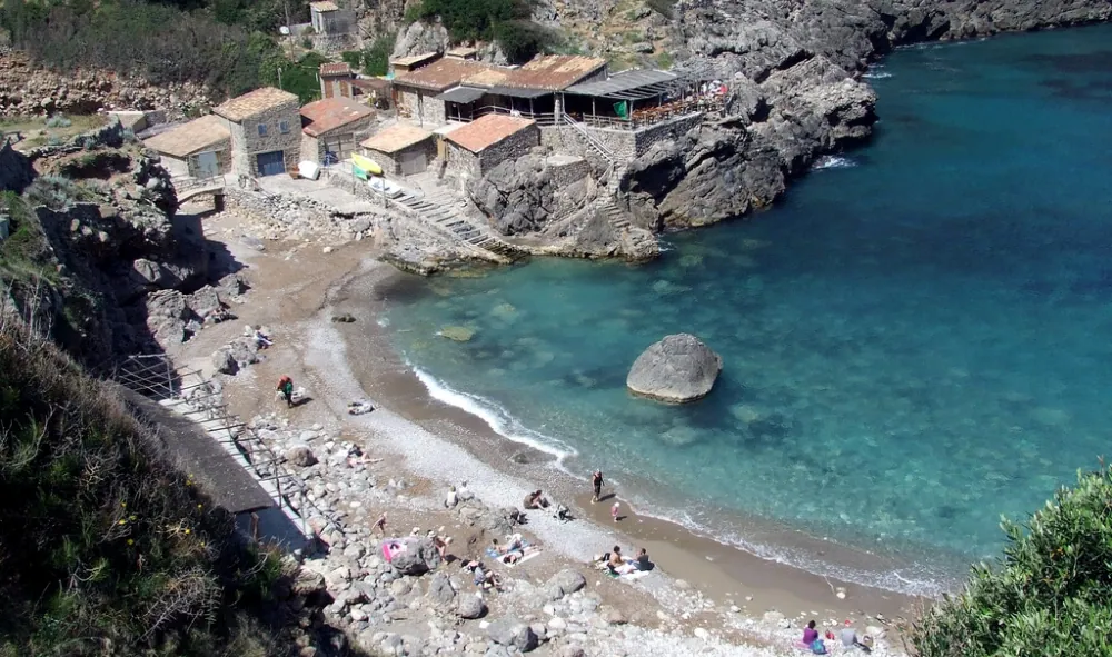 Elevated view of Cala Deià cove and crystal-clear waters