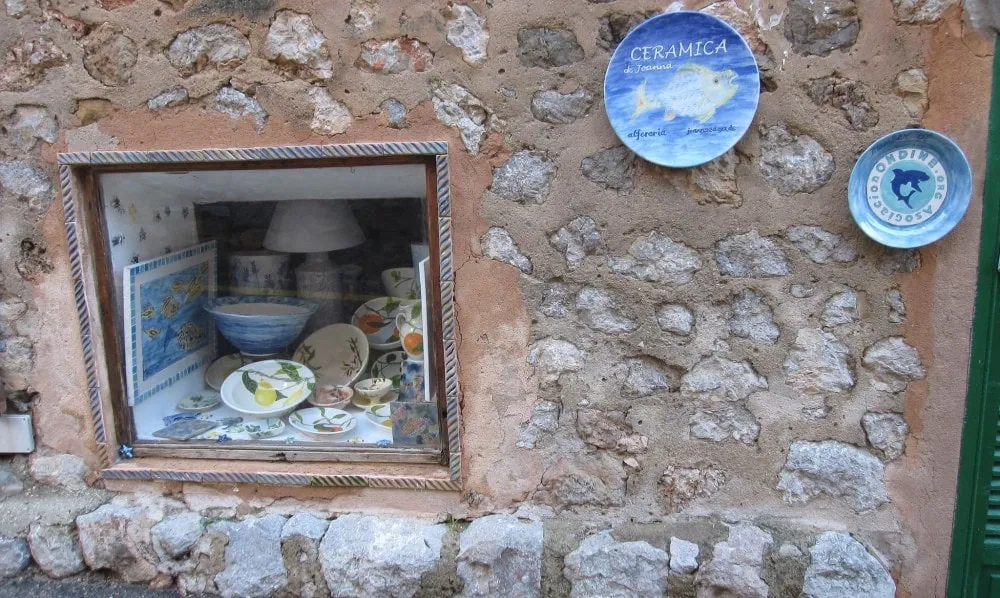 A traditional craftwork and pottery shop on a village street in Deià