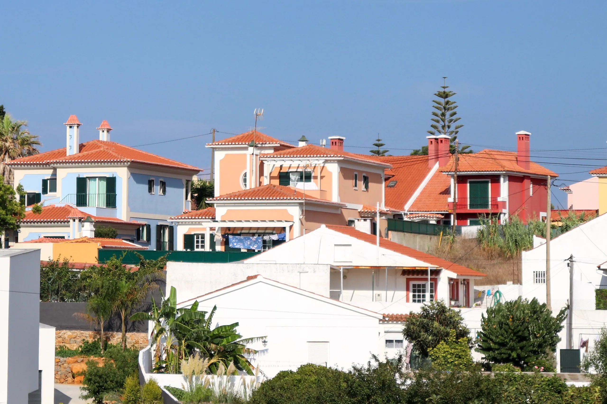 Detached houses with red tiled roofs in a town near Lisbon