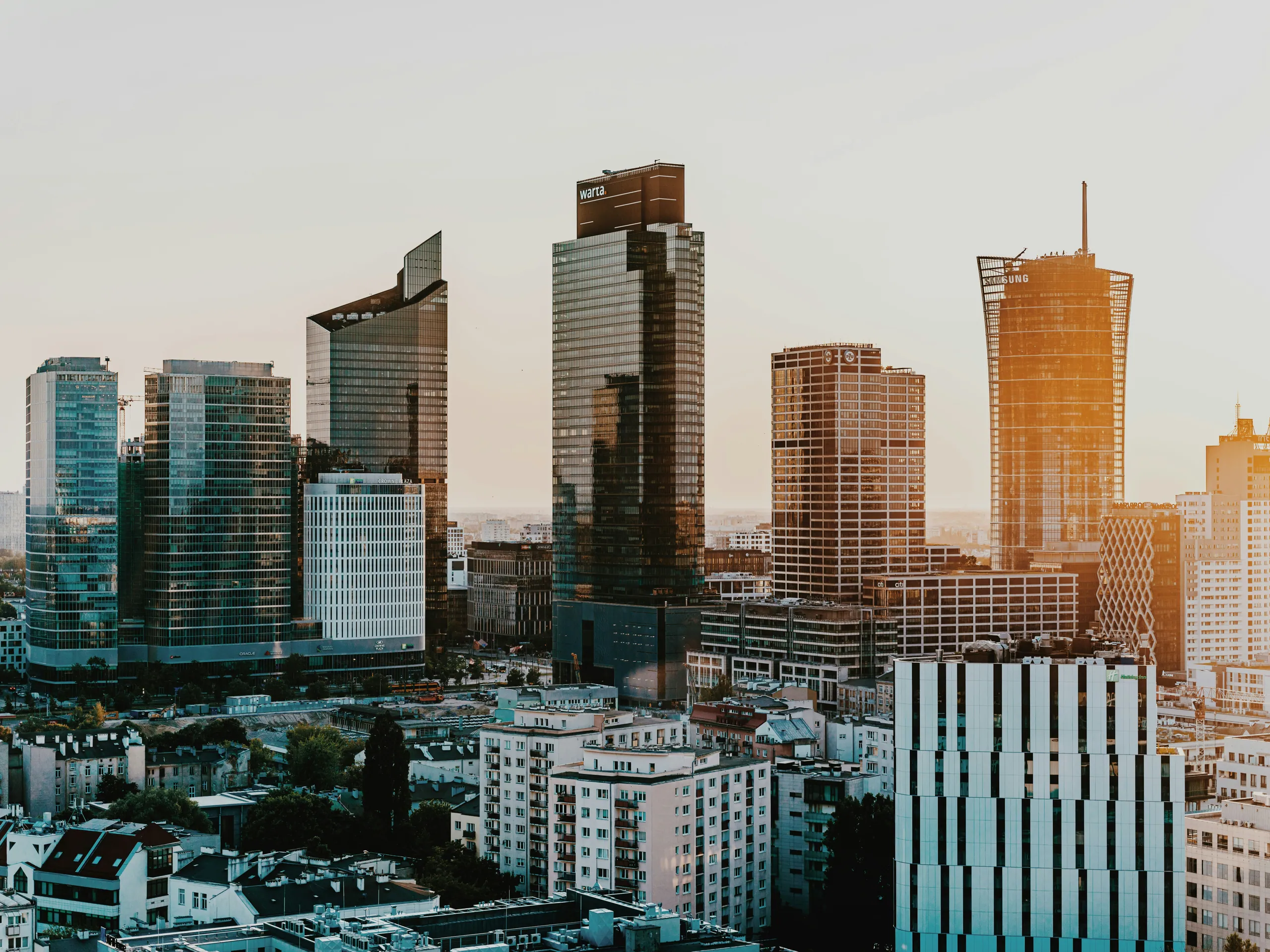 Warsaw city-centre skyline of office towers at sunset